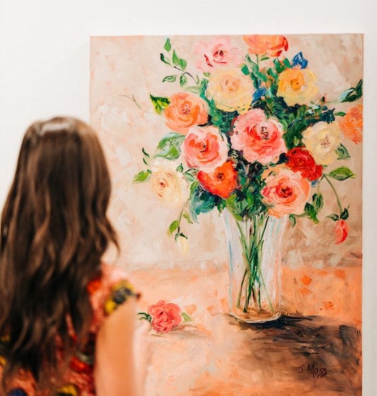 Girl admiring a beautiful rose painting at The Roseberry, Columbia, South Carolina